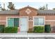 Close-up of the townhome featuring a secure front entrance and manicured bushes at 2110 Sleepy Ct, Las Vegas, NV 89106