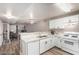 Modern kitchen boasts white cabinets, granite countertops, and stainless steel appliances at 2110 Sleepy Ct, Las Vegas, NV 89106