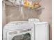 The functional laundry area features a washer, dryer, and storage shelf at 2110 Sleepy Ct, Las Vegas, NV 89106