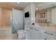Well-lit bathroom featuring a tub-shower, white cabinets, and neutral stone tile at 222 Karen Ave # 1804, Las Vegas, NV 89109