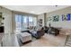Open living space with a gray sofa, city views, and dining area adjacent to the kitchen at 222 Karen Ave # 1804, Las Vegas, NV 89109