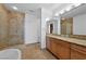 Bathroom with tiled floors, stand alone tub, glass shower, and granite countertop at 2260 Village Walk Dr # 1305, Henderson, NV 89052