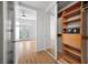 Walk-in closet with custom shelving and a mirrored sliding door to the main bedroom at 2260 Village Walk Dr # 1305, Henderson, NV 89052