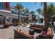 Inviting outdoor retail area with comfortable seating, palm trees, and a splash fountain at 2260 Village Walk Dr # 1305, Henderson, NV 89052