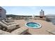 Expansive rooftop deck with jacuzzi, lounge chairs, and mountain views at 2260 Village Walk Dr # 1305, Henderson, NV 89052
