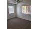 A bright bedroom with dual windows, a ceiling fan, and comfortable carpet flooring at 230 Mission Catalina Ln # 204, Las Vegas, NV 89107