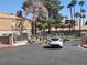 Gated community entrance with a white car waiting, showing the controlled access and secure environment at 230 Mission Catalina Ln # 204, Las Vegas, NV 89107