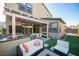 Beautiful backyard area with covered patio, built-in BBQ, outdoor seating and lush grass at 2510 Verdello St, Henderson, NV 89044