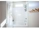 Clean, white bathroom with neutral walls, white shower curtain, and minimalist decor at 2510 Verdello St, Henderson, NV 89044