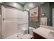 Modern bathroom showcasing a glass-enclosed shower with subway tile, a vanity with solid surface countertops and desert artwork at 2510 Verdello St, Henderson, NV 89044