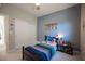 Cozy bedroom featuring a comfortable bed, playful decorations, and a closet with sliding doors, designed for comfort at 2510 Verdello St, Henderson, NV 89044