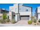 Modern two-story home features a gray color scheme, stone accents, and a two-car garage at 2510 Verdello St, Henderson, NV 89044