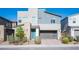 Modern two-story home features a gray color scheme, stone accents, and a two-car garage at 2510 Verdello St, Henderson, NV 89044