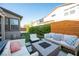 Cozy backyard with a fire pit, comfortable seating, and green landscaping for relaxation and enjoyment at 2510 Verdello St, Henderson, NV 89044