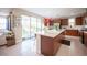 Spacious kitchen with island, stainless appliances, and sliding glass doors opening to the outdoor dining area at 2510 Verdello St, Henderson, NV 89044