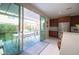 Modern kitchen featuring seamless indoor/outdoor living with sliding glass doors to the covered patio and outdoor kitchen at 2510 Verdello St, Henderson, NV 89044