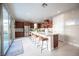 Modern kitchen with stainless steel appliances, a large island with seating, and sliding doors to outdoor patio at 2510 Verdello St, Henderson, NV 89044