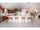 Bright kitchen with a large island, seating, stainless steel appliances, and easy access to the staircase at 2510 Verdello St, Henderson, NV 89044