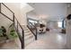 Open floor plan with staircase leading to a spacious living and dining area filled with natural light and modern decor at 2510 Verdello St, Henderson, NV 89044