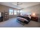 A stylish main bedroom with decorative wallpaper, and a seating bench at the foot of the bed at 2510 Verdello St, Henderson, NV 89044