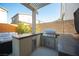 Outdoor kitchen features a built-in grill, countertop and seating, perfect for entertaining at 2510 Verdello St, Henderson, NV 89044