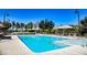 Resort style community pool with lounge chairs and umbrellas, perfect for relaxing in the sun at 2510 Verdello St, Henderson, NV 89044