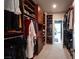 Spacious walk-in closet with custom wood shelving and ample storage space for clothing and accessories at 2510 Verdello St, Henderson, NV 89044