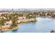 Lakefront homes and a cityscape in the distance surrounded by trees and green spaces at 2608 Sun Reef Rd, Las Vegas, NV 89128