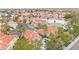 Community with homes with red tile roofs near a lake and surrounded by palm trees at 2608 Sun Reef Rd, Las Vegas, NV 89128