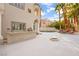 Luxurious backyard featuring a built-in BBQ, outdoor fireplace and lush palm trees at 2608 Sun Reef Rd, Las Vegas, NV 89128