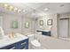 Bathroom features double sink vanity with blue cabinets and a large mirror at 2608 Sun Reef Rd, Las Vegas, NV 89128