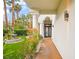 Inviting entryway with lush landscaping, artificial turf and a tranquil fountain at 2608 Sun Reef Rd, Las Vegas, NV 89128