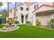 Luxurious home featuring beautiful landscaping, manicured lawn and elegant architectural details at 2608 Sun Reef Rd, Las Vegas, NV 89128