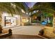 Expansive backyard with palm trees, built-in BBQ, and inviting pool with waterfall feature at 2608 Sun Reef Rd, Las Vegas, NV 89128