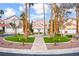 Well-manicured front yard featuring mature palm trees, desert landscaping and circular driveway with a fountain at 2608 Sun Reef Rd, Las Vegas, NV 89128