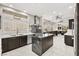 Gourmet kitchen featuring stainless steel appliances, dark cabinets, and marble countertops at 2608 Sun Reef Rd, Las Vegas, NV 89128