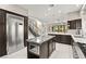 Spacious kitchen with stainless steel refrigerator and staircase in view at 2608 Sun Reef Rd, Las Vegas, NV 89128