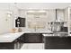 Well-lit kitchen showcases white counters, dark cabinets and modern stainless hood at 2608 Sun Reef Rd, Las Vegas, NV 89128