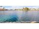 Scenic lakefront view with serene blue water and lush landscaping creating an idyllic waterfront panorama at 2608 Sun Reef Rd, Las Vegas, NV 89128