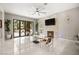 Bright living room featuring a fireplace, fan, and folding glass doors at 2608 Sun Reef Rd, Las Vegas, NV 89128