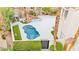 Backyard with a swimming pool, hot tub, waterfall feature, and well-maintained landscaping at 2608 Sun Reef Rd, Las Vegas, NV 89128