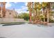 Inviting pool area with rock waterfall feature, palm trees, and stylish design at 2608 Sun Reef Rd, Las Vegas, NV 89128
