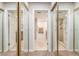 Bright bathroom featuring tiled floors, shower, and granite countertop vanity with double doors and mirrored closet at 2645 Heritage Ct, Las Vegas, NV 89121