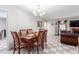 Dining room featuring tiled floors, neutral decor, and view into the living room with fireplace at 2645 Heritage Ct, Las Vegas, NV 89121