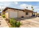 Charming single-story home with a white garage door and desert landscaping at 2645 Heritage Ct, Las Vegas, NV 89121