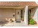 View of the front door entrance with a security gate and low maintenance desert landscaping at 2645 Heritage Ct, Las Vegas, NV 89121
