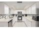 Well-lit kitchen boasting white cabinetry, tiled backsplash, and stainless steel appliances for a modern touch at 2645 Heritage Ct, Las Vegas, NV 89121