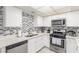 Updated kitchen featuring quartz countertops, stainless appliances, and ample storage space at 2645 Heritage Ct, Las Vegas, NV 89121