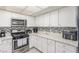 Bright kitchen featuring tiled backsplash, stainless steel oven, and new appliances at 2645 Heritage Ct, Las Vegas, NV 89121