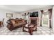 Living room featuring tiled floors, fireplace, neutral decor, and bright, natural light at 2645 Heritage Ct, Las Vegas, NV 89121